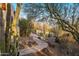 Wide outdoor shot of landscaping with cacti, bushes, trees, mulch and stones along a stone walkway at 25002 N Quail Haven Dr, Rio Verde, AZ 85263