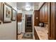 Cozy laundry room with tiled counters, wood cabinets, a washer/dryer, and natural light from the door at 25002 N Quail Haven Dr, Rio Verde, AZ 85263