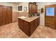 Spacious laundry room featuring tile flooring, ample cabinet space, sink, and convenient access door at 25002 N Quail Haven Dr, Rio Verde, AZ 85263