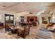 Spacious living room showcasing high wood-beam ceilings and terracotta flooring at 25002 N Quail Haven Dr, Rio Verde, AZ 85263