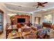 Cozy living room featuring wood beam ceiling, terracotta floor, and wood furniture at 25002 N Quail Haven Dr, Rio Verde, AZ 85263