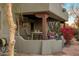 A cozy covered patio area features an outdoor dining table, an outdoor fan and various plants at 25002 N Quail Haven Dr, Rio Verde, AZ 85263