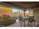 Cozy covered patio featuring a dining table, chairs and desert views perfect for relaxed outdoor meals at 25002 N Quail Haven Dr, Rio Verde, AZ 85263