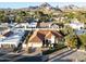 Stunning aerial view of a red-roofed home nestled in a lush, green neighborhood with mountain views at 2514 E Montebello Ave, Phoenix, AZ 85016