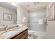 Bathroom vanity with granite countertop and decorative fixtures complemented by a shower with glass doors at 2514 E Montebello Ave, Phoenix, AZ 85016