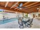 Inviting covered patio with fan, dining table, and direct view of the pool at 2514 E Montebello Ave, Phoenix, AZ 85016