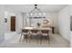 Bright dining room featuring a modern chandelier, neutral walls, and a view of the front door at 2514 E Montebello Ave, Phoenix, AZ 85016