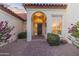 Inviting front entrance featuring a brick walkway, arched doorway, and decorative landscaping at 2514 E Montebello Ave, Phoenix, AZ 85016