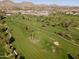 Scenic aerial view of a golf course with green fairways, mature trees, and distant mountain views at 2514 E Montebello Ave, Phoenix, AZ 85016