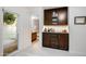 Transitional hallway with wood cabinets and an entryway to a bathroom create a smooth flow and enhanced living space at 2514 E Montebello Ave, Phoenix, AZ 85016