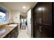 Hallway with ample cabinetry and granite counters leads to kitchen and backyard at 2514 E Montebello Ave, Phoenix, AZ 85016