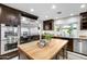 Bright kitchen with stainless steel refrigerator, wood island, and plentiful cabinet storage at 2514 E Montebello Ave, Phoenix, AZ 85016