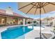 Inviting backyard pool area with a well-maintained pool, umbrella, and lounge chairs for relaxation at 2514 E Montebello Ave, Phoenix, AZ 85016