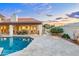 Expansive travertine patio with a swimming pool, lounge area, and outdoor seating, ideal for outdoor living at 2514 E Montebello Ave, Phoenix, AZ 85016