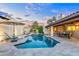 Stylish travertine pool deck, lounge chairs, tables, and shaded seating perfect for enjoying the outdoors at 2514 E Montebello Ave, Phoenix, AZ 85016