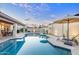 Tranquil pool area featuring a pristine pool with a travertine surround, lounge seating and shaded seating at 2514 E Montebello Ave, Phoenix, AZ 85016