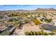 Expansive aerial view of a residential neighborhood with mountain views and mature landscaping at 2525 E Misty Willow Ln, Phoenix, AZ 85024