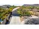 Aerial view of a single Gathering house featuring a concrete driveway, desert landscaping, and privacy fence at 2525 E Misty Willow Ln, Phoenix, AZ 85024