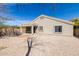 An inviting backyard featuring desert landscaping, a covered patio, and a cozy seating area at 2525 E Misty Willow Ln, Phoenix, AZ 85024