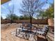 Backyard patio featuring desert landscaping and outdoor furniture with black and white striped cushions at 2525 E Misty Willow Ln, Phoenix, AZ 85024