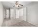 Carpeted bedroom featuring a ceiling fan and multiple closet doors at 2525 E Misty Willow Ln, Phoenix, AZ 85024