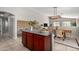 Kitchen island with dark countertops and a dining area with a light fixture at 2525 E Misty Willow Ln, Phoenix, AZ 85024