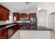 A spacious kitchen featuring granite counters, stainless steel appliances, and ample cabinet space at 2525 E Misty Willow Ln, Phoenix, AZ 85024