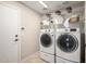 Functional laundry room featuring a washer, dryer, wire shelving, and a tile floor at 2525 E Misty Willow Ln, Phoenix, AZ 85024