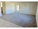 Bright, spacious living room with new carpet, ample natural light and neutral wall colors at 25678 N Boreas Rd, Florence, AZ 85132