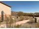 Backyard landscaping featuring desert vegetation, walkway and rod iron fence at 27575 N Dolores Pl, San Tan Valley, AZ 85144