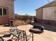 Backyard with a fire pit, seating, and an iron gate leading to a view at 27575 N Dolores Pl, San Tan Valley, AZ 85144