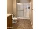 Bathroom featuring a glass-enclosed shower with a white tile surround, and a toilet at 27575 N Dolores Pl, San Tan Valley, AZ 85144