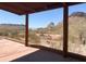 Expansive desert view from covered patio and framed by wood beams at 27575 N Dolores Pl, San Tan Valley, AZ 85144