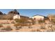 Exterior view features low-rise homes amidst arid desert landscaping at 27575 N Dolores Pl, San Tan Valley, AZ 85144