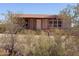 Exterior of home features desert landscaping and covered porch at 27575 N Dolores Pl, San Tan Valley, AZ 85144