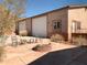 Attached two-car garage with a firepit and seating in front of the doors at 27575 N Dolores Pl, San Tan Valley, AZ 85144