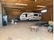 Spacious garage featuring a recreational vehicle and ample storage space at 27575 N Dolores Pl, San Tan Valley, AZ 85144