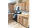 Well-equipped kitchen showcasing wooden cabinets, black stove and a microwave at 27575 N Dolores Pl, San Tan Valley, AZ 85144