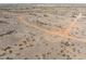 An aerial view showcasing sprawling desert landscape with cacti and natural dirt road at 27864 N 158Th Ave, Surprise, AZ 85387