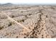 Aerial view of desert land showing native vegetation and a dirt path amid a scenic landscape at 27864 N 158Th Ave, Surprise, AZ 85387