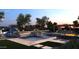 Luxurious backyard pool featuring a slide, hot tub, outdoor kitchen, and lounge area at 27864 N 158Th Ave, Surprise, AZ 85387