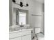 Bathroom featuring white vanity, framed mirror, and toilet at 286 W Palomino Dr # 101, Chandler, AZ 85225