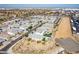 Extensive aerial view of a neighborhood with diverse architectural styles and well-kept desert landscaping under a clear blue sky at 3029 S 78Th Dr, Phoenix, AZ 85043