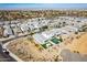 Overhead view of a residential area with varied home styles and green outdoor spaces against the backdrop of a clear sky at 3029 S 78Th Dr, Phoenix, AZ 85043