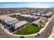 Expansive aerial view of a residential community with well-maintained lawns and a playground on a sunny day at 3029 S 78Th Dr, Phoenix, AZ 85043