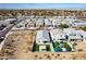 High-angle aerial shot of a community featuring modern homes with landscaped yards and vibrant green turf at 3029 S 78Th Dr, Phoenix, AZ 85043