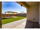 Back patio with a covered outdoor seating area, surrounded by lush artificial turf and a block fence at 3029 S 78Th Dr, Phoenix, AZ 85043