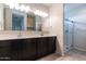 Bathroom featuring double vanity, large mirror, and glass enclosed walk-in shower at 3029 S 78Th Dr, Phoenix, AZ 85043