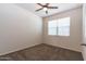 Neutral bedroom with carpet, a ceiling fan, and bright, natural light at 3029 S 78Th Dr, Phoenix, AZ 85043