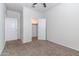 A bedroom with neutral walls and plush carpeting leads to a walk-in closet at 3029 S 78Th Dr, Phoenix, AZ 85043